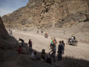 Almost completing their journey through Titus Canyon Narrows Mark Buche on a Honda CRF250L and Jun Villegas, riding a Suzuki DR-Z 400 encounter a geography class, field trip from West Hills College of Lemoore, Calif., exploring the desert, during their recent three day visit to Death Valley National Park.