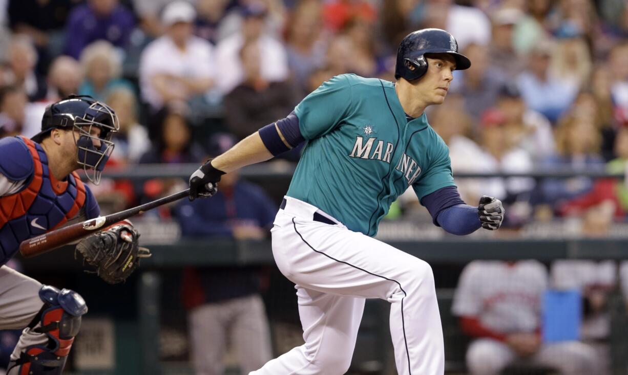 Seattle's Logan Morrison singles in a run as Boston catcher A.J.