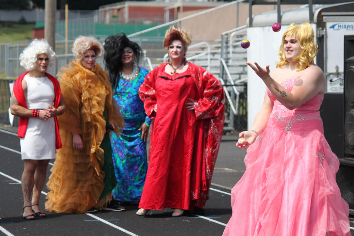 Jacob Atkinson, of Team M.A.C. (Minions Against Cancer), juggles as part of the talent segment of the &quot;Misster Relay&quot; pageant. It was held Saturday afternoon, during the 24-hour Relay for Life at Fishback Stadium at Washougal High School. Looking on are (right to left) Daris Freimuth, Brandon Renninger and Kamu Cheek of the Walmart Walkers, and Steven Phillips of the Wayward Women of Washougal.