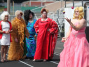 Jacob Atkinson, of Team M.A.C. (Minions Against Cancer), juggles as part of the talent segment of the &quot;Misster Relay&quot; pageant. It was held Saturday afternoon, during the 24-hour Relay for Life at Fishback Stadium at Washougal High School. Looking on are (right to left) Daris Freimuth, Brandon Renninger and Kamu Cheek of the Walmart Walkers, and Steven Phillips of the Wayward Women of Washougal.