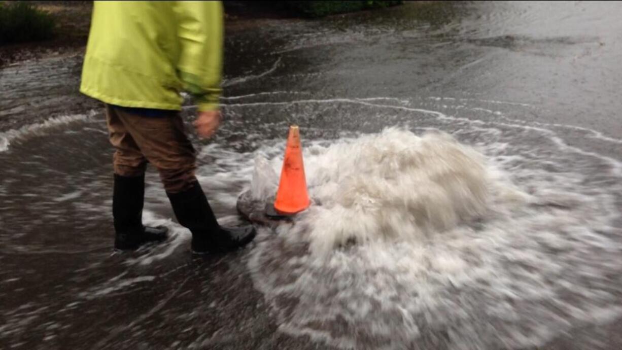 Water covers the roadway Wednesday evening at the intersection of 95th Avenue and 14th Street, north of Highway 14 in Vancouver's Ellsworth Springs neighborhood.