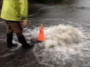 Water covers the roadway Wednesday evening at the intersection of 95th Avenue and 14th Street, north of Highway 14 in Vancouver's Ellsworth Springs neighborhood.