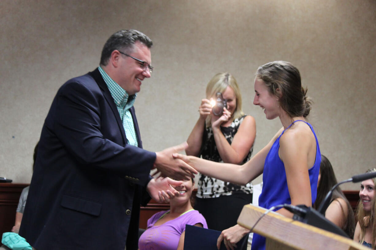 Accomplished distance runner Alexa Efraimson is congratulated by Camas Mayor Scott Higgins on Monday night, following his proclamation that Friday, Aug. 8, would be &quot;Alexa Efraimson Appreciation Day.&quot; Efraimson, who will be a senior at Camas High School in the fall, has a long list of state and national track and cross country accolades, including Gatorade National Girls Cross Country Runner of the Year.