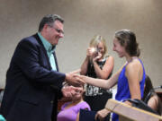 Accomplished distance runner Alexa Efraimson is congratulated by Camas Mayor Scott Higgins on Monday night, following his proclamation that Friday, Aug. 8, would be &quot;Alexa Efraimson Appreciation Day.&quot; Efraimson, who will be a senior at Camas High School in the fall, has a long list of state and national track and cross country accolades, including Gatorade National Girls Cross Country Runner of the Year.