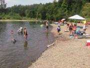 Area residents spent time at the Sandy Swimming Hole Monday, enjoying picnics, sunbathing, rafting and cooling off in the Washougal River, as temperatures neared 100 degrees.