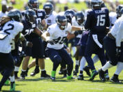 Seattle Seahawks linebacker Brock Coyle (45), center, takes part in a practice drill during NFL football training camp, Thursday, July 31, 2014, in Renton, Wash.