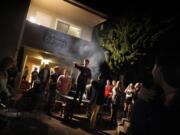 Students eat burgers and mingle at the Jesus Burgers house in May in Santa Barbara, Calif.'s Isla Vista neighborhood.