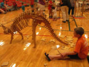 Constructing a dinosaur skeleton was just one of the many hands-on activities children could participate in during the  OMSI Science Festival at Hathaway Elementary School on Wednesday.