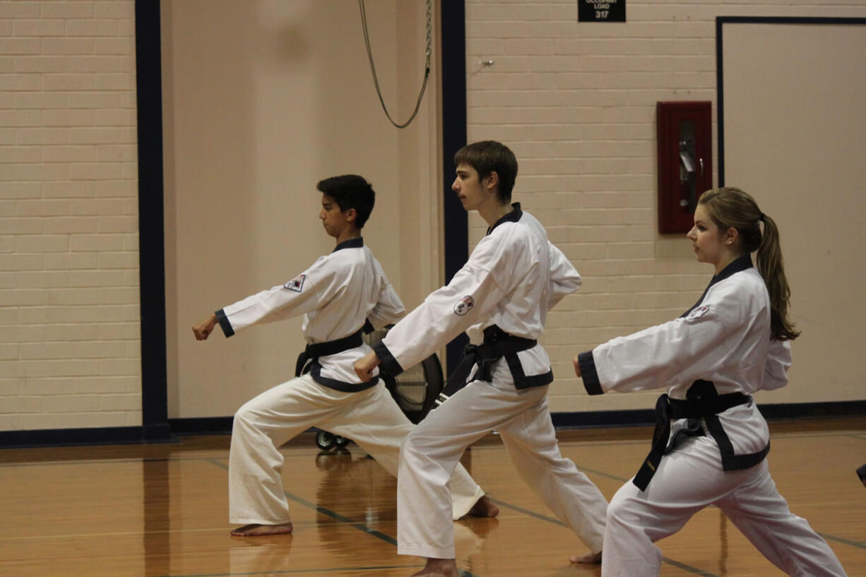 Award winners Sean Oulashin, Jordan Johnson and Miranda Dean practice correct form while doing front kicks. At the U.S.