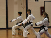 Award winners Sean Oulashin, Jordan Johnson and Miranda Dean practice correct form while doing front kicks. At the U.S.