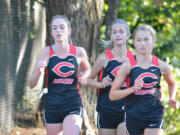 Camas cross country runners, from left, Emma Jenkins, Emily Wilson and Rachel Blair compete during a meet this season at Round Lake Park in Camas.