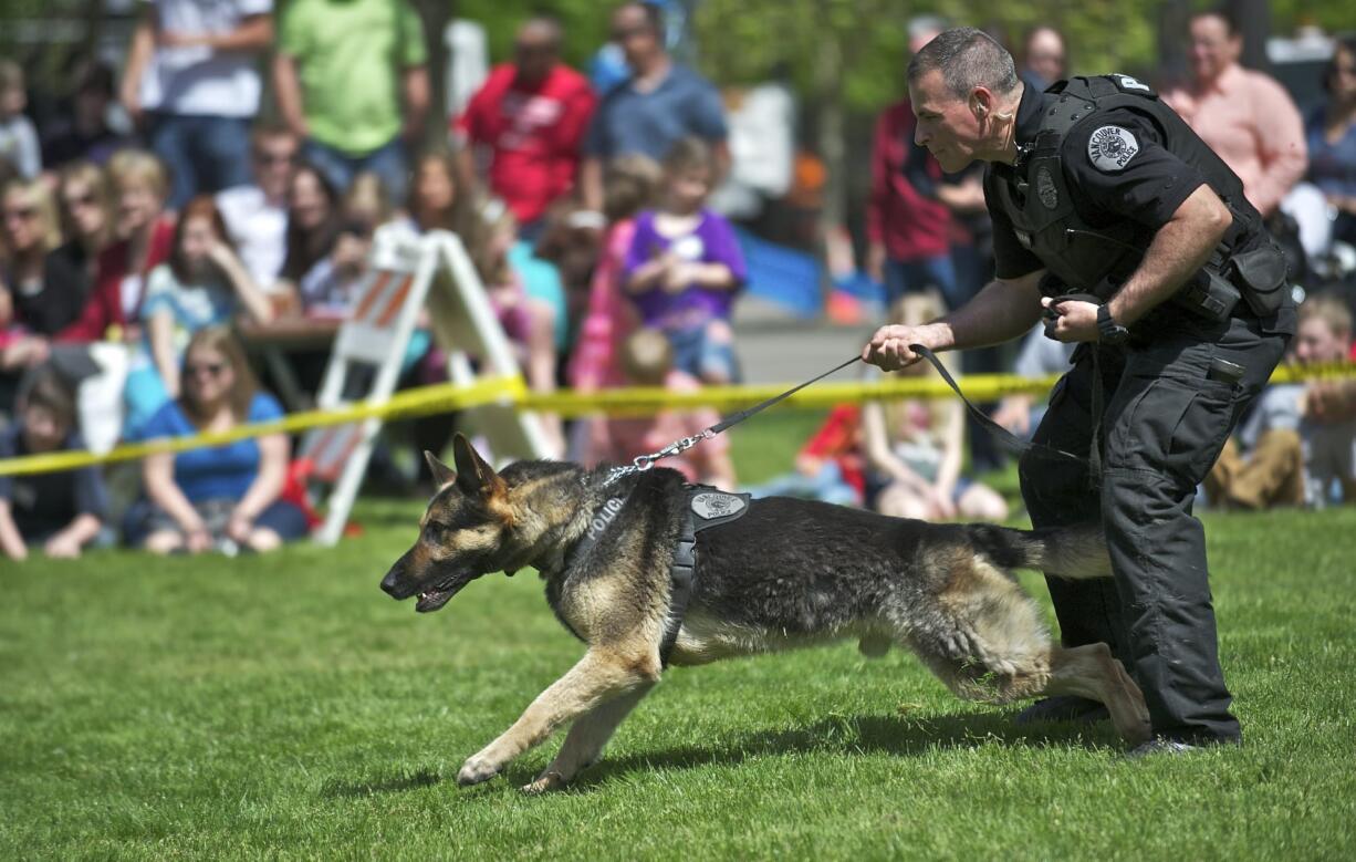 Vancouver police Officer Roger Evans and his German shepherd, Eron, participate in a police K-9 demonstration for children near the Clark County Courthouse April 25, 2013.