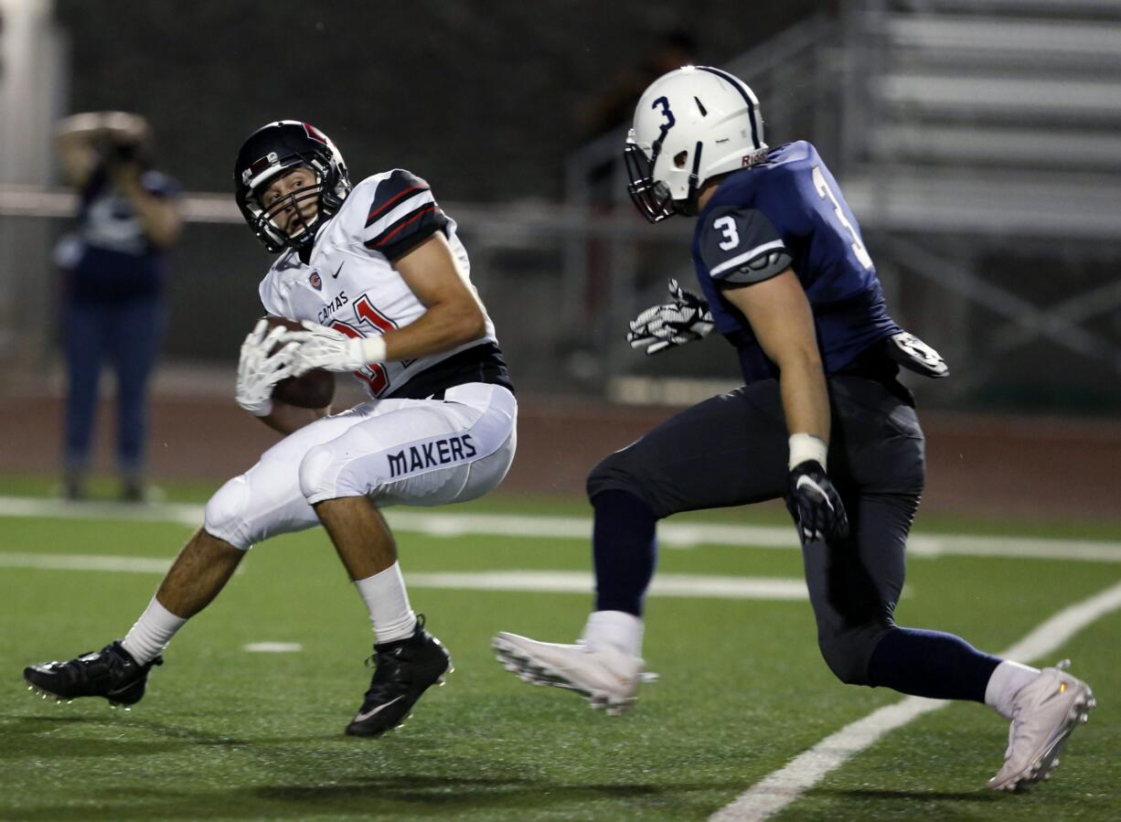 Camas High School's Michael Boyle (11) catches a ball over Chiawana High School's Caleb Weber (3) Friday during a game at Edgar Brown Memorial Stadium in Pasco.