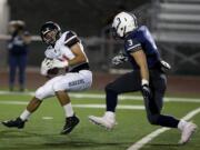 Camas High School's Michael Boyle (11) catches a ball over Chiawana High School's Caleb Weber (3) Friday during a game at Edgar Brown Memorial Stadium in Pasco.