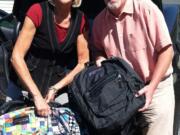 Dawn Tarzian and Mike Nerland, superintendents of the Washougal and Camas school districts, delivered 220 backpacks to school administrators to distribute to children in need.