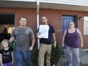 From left, Lilly Corder, Andrew Rickard, Brian Myers, holding the vacate notice, and Jaimie Lewis at the apartment complex where residents are being progressively issued vacate notices, at 1304 NE 88th in Hazel Dell, Wa., Wednesday Sept 9, 2015.