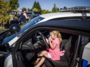 4-year-old Kinley Goertler from Camas gets hands-on with the inside of a City Of Vancouver Police patrol car during a recruitment event, that she inspired, for girls curious about careers in law enforcement Wednesday at the Vancouver Police East Precinct.