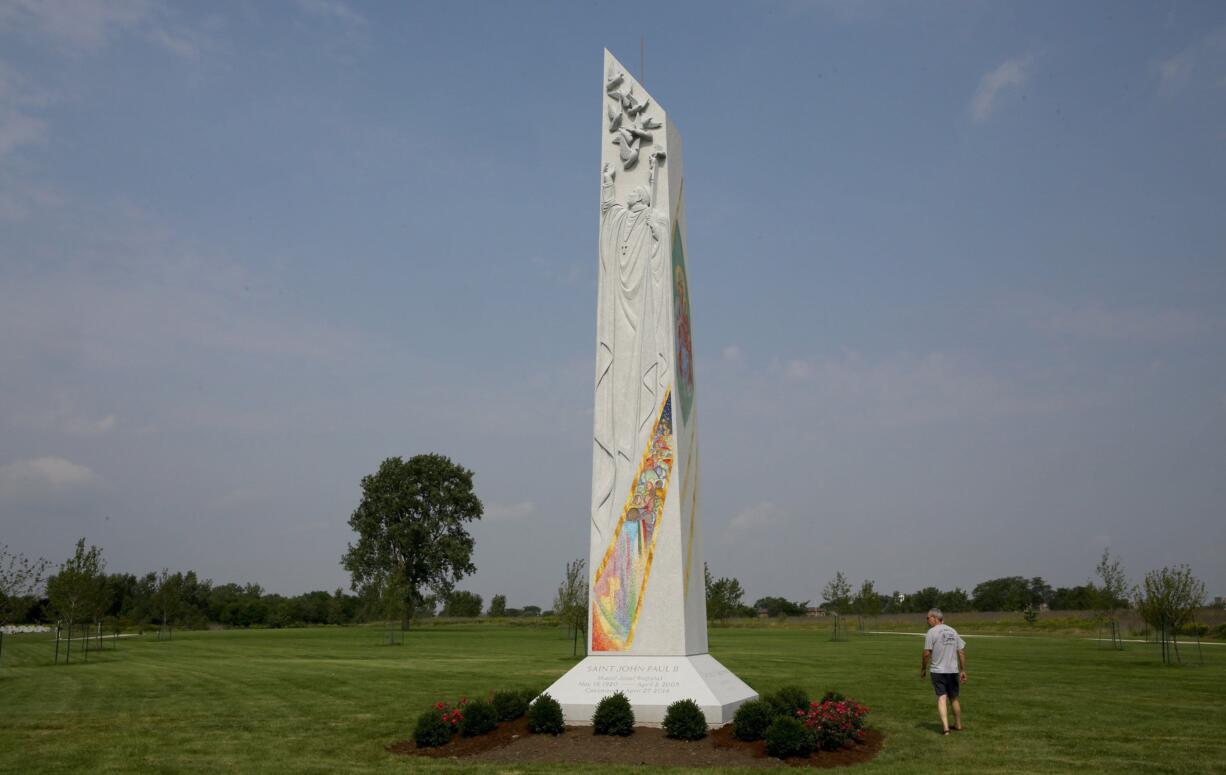 Edmund Courtney looks over the new 32-foot sculpture honoring St. John Paul II while visiting Maryhill Cemetery in Niles, Ill.