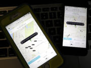 Smart phones display Uber car availability last year in New York.