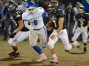 Battle Ground quarterback Gunner Talkington (7) threw for 503 yards and six touchdowns, but relied on his legs for this gain against Mountain View.