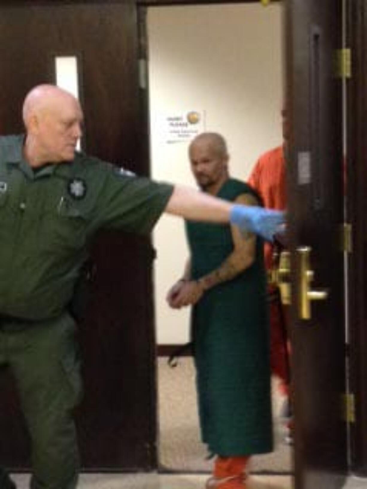 Ronald Ahlquist, 45, is escorted out of Clark County Superior Court after making a first court appearance on suspicion on second-degree manslaughter.