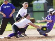 Mountain View's Lauren Warner slides into third under the tag of Prairie pitcher Irene McGuire as third baseman Jordan Shaw backs her up during a game, Monday, April 28, 2014.