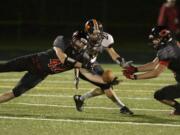 Camas defender Gabe Lopes, left, was one of three local high school football players named first-team all-state.