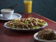 Farm-style potatoes with the gravy on the side and a homemade caramel and nut roll are among the menu items at Christine's Restaurant in Vancouver.