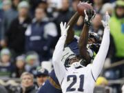 Seattle Seahawks wide receiver Paul Richardson, top, makes a leaping reception against the defense of St. Louis Rams' Janoris Jenkins (21) in the second half Sunday, Dec.