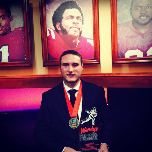 Union High School senior Nolan Henry with the 2014 Wendy's High School Heisman award, presented to him on Friday, Dec. 12, 2014 in New York.