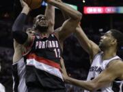 Portland's LaMarcus Aldridge (12) and the Blazers had it rough against San Antonio in the playoffs last season.