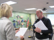 Dawn Tarzian, Washougal School District superintendent, administers the oath of office to Bruce Westfall, the newest School Board member.