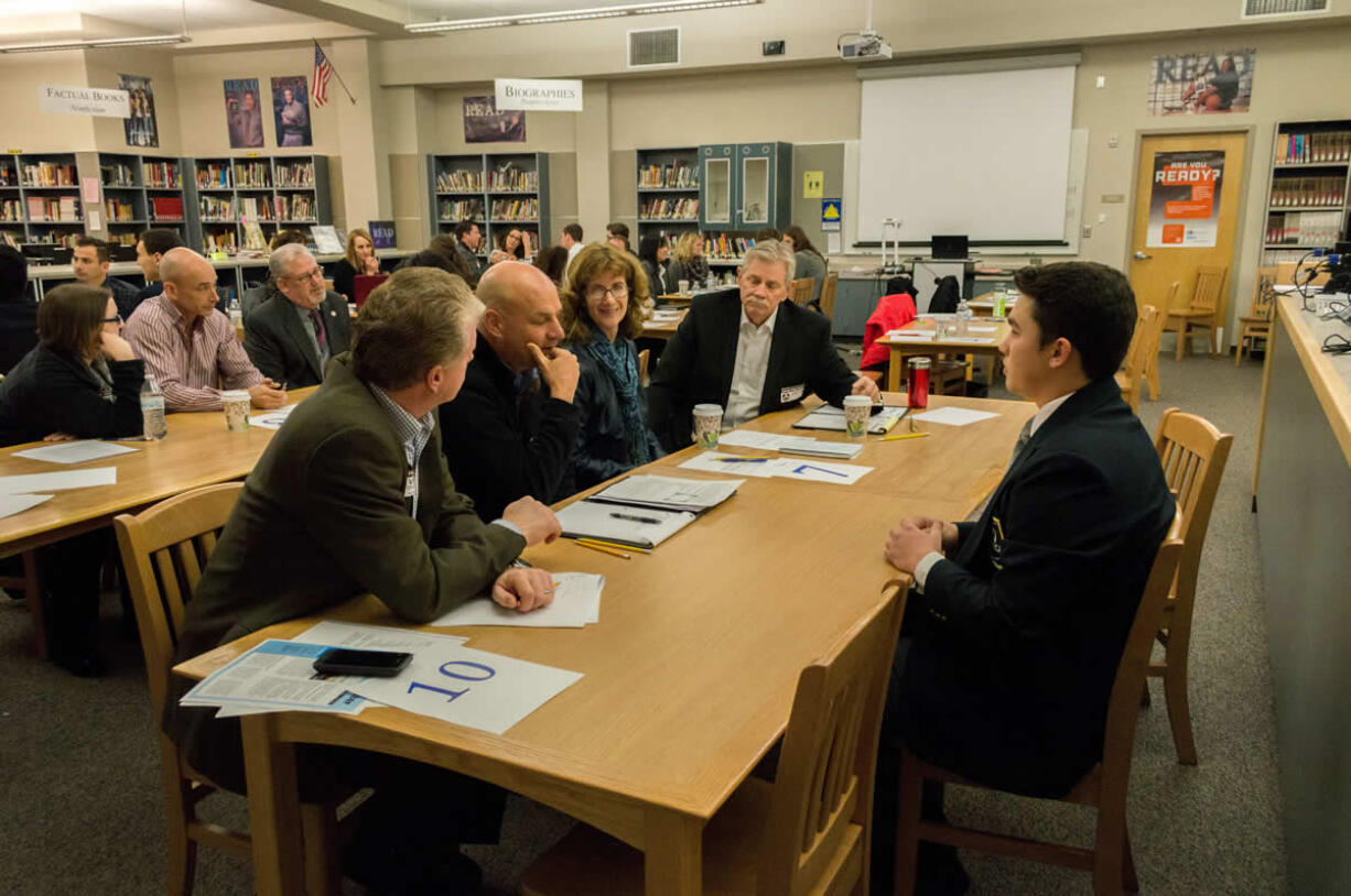 Cameron Vega, Camas High School DECA chapter president,  presents his public relations campaign to business and community members including Bracy Ratcliff, Crawford Tuttle, Mark Klein and Dana Coates.