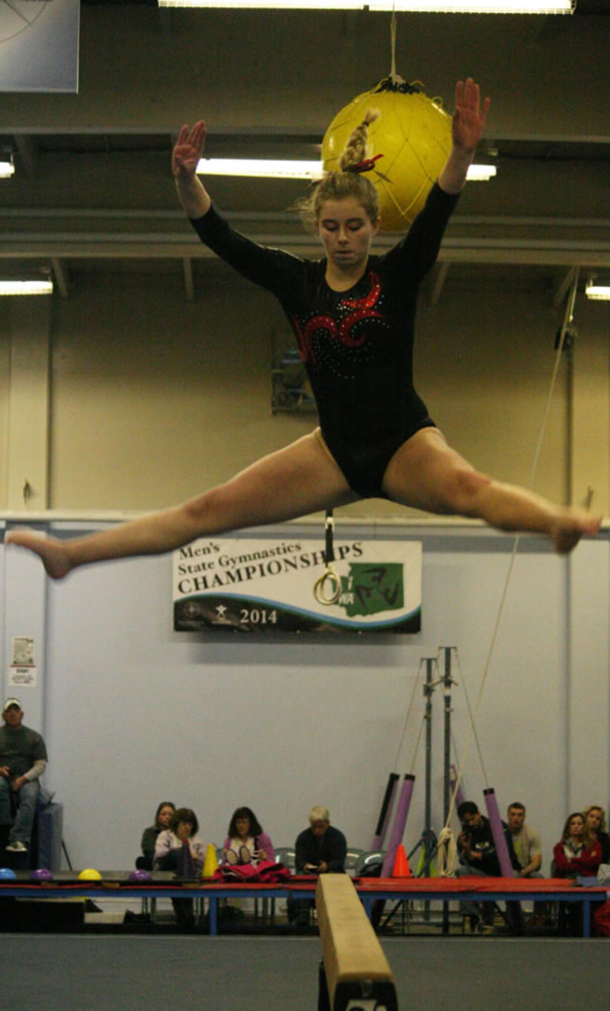 Alexis Sabatini leaps high off the balance beam for Camas.