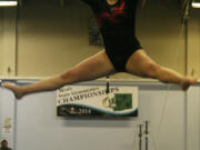 Alexis Sabatini leaps high off the balance beam for Camas.