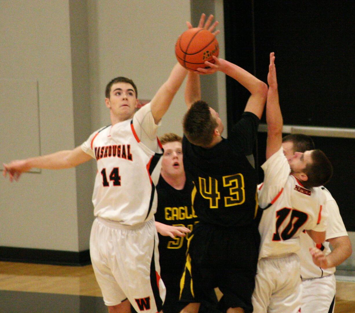 Ryan Taylor (14) and Daniel Davis contest a shot by Hudson's Bay Monday, at Washougal High School.