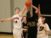 Ryan Taylor (14) and Daniel Davis contest a shot by Hudson's Bay Monday, at Washougal High School.