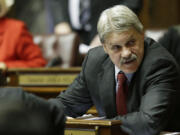 Sen. Tim Sheldon, D-Potlatch, sits at his desk on the Senate floor in Olympia in 2013.