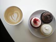 A double-shot latte and assorted cupcakes are among the offerings at Cupidone Coffee House in Vancouver.