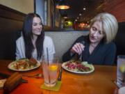 Alexis Colson, left, and her mother Mary Thompson speak about bulimia and healthy eating habits during a recent interview at the Outback Steakhouse in Vancouver.