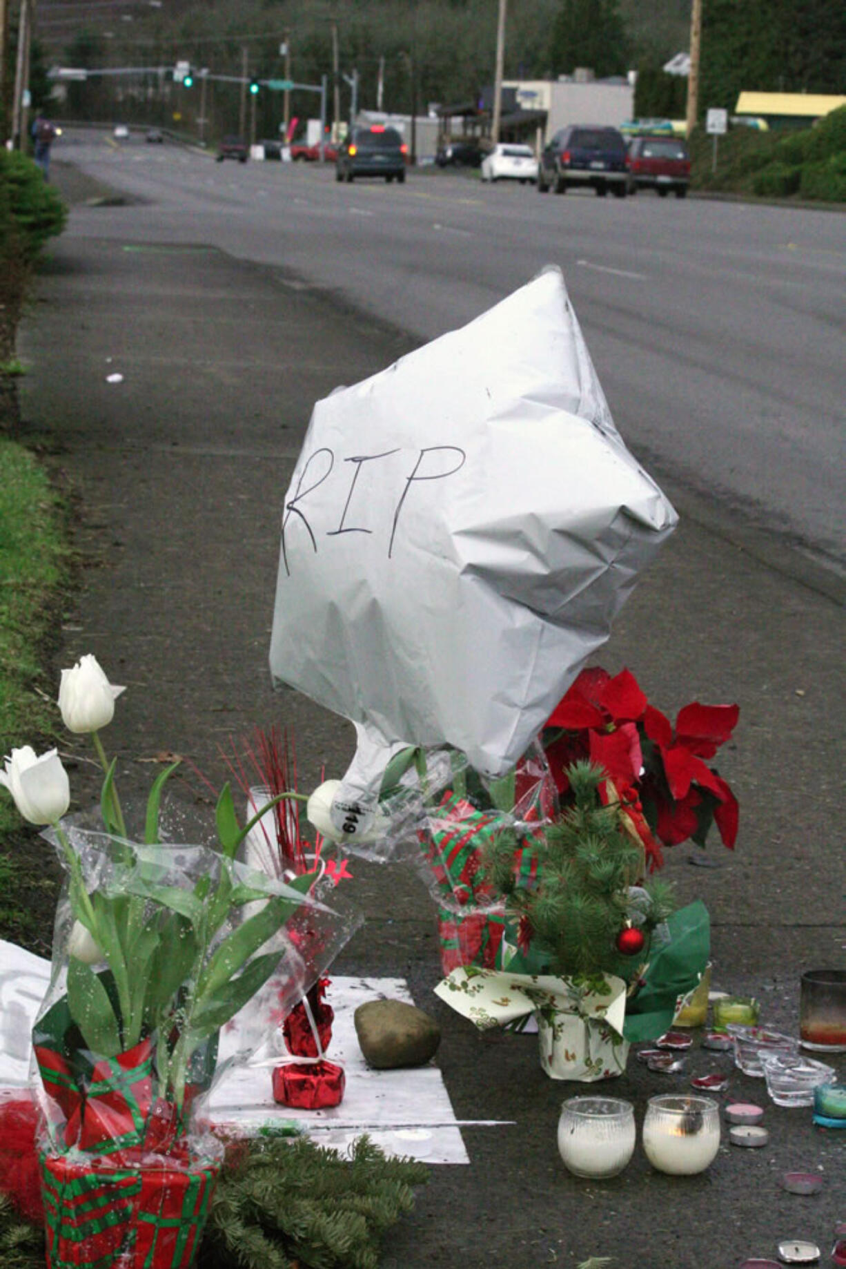 A memorial of flowers, candles, balloons and other tributes to Anneice Fich has grown during the past week at Northeast Third Avenue and Weir Street in Camas. Nearby on Dec. 23, Fich was pushing a stroller that held her great-grandson, Eduardo Herrera-Berra, 2, while crossing the street when she was hit by a vehicle. Fich, 66, died at the scene, while Herrera-Berra was hospitalized for injuries including broken ribs, a punctured lung and a fractured leg. He was released Dec.