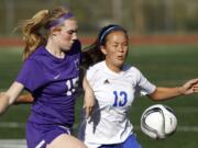 Mountain View's Lilah Favour (13) and Columbia River's Katie Anthony (15) battle for the ball in girls soccer.