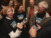 Clark County home rule charter supporters, from left, Betty Sue Morris, Patty Reyes and Joe Toscano check early election results Nov. 4 at a rally in The Grant House.