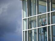 Zachary Kaufman/The Columbian
A worker polishes a window on one of the big additions to Ridgefield High School. The building houses several new spaces, including a gym, auditorium and cafeteria.