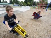 Nicholas Caruthers, 7, left, and Toby Caruthers, 10, both from Vancouver, play at the Yacolt Town Park.