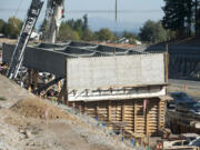 A set of three steel girders sits along Interstate 205 in Vancouver on Tuesday. Construction crews are installing a total of 15 large girders this week as part of a new interchange connecting I-205 and Northeast 18th Street.