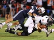 Battle Ground's Kyle Cahoon is tackled by Skyview's Devon Whitley during a game at the Kiggens Bowl in Vancouver, Friday September 17, 2015.