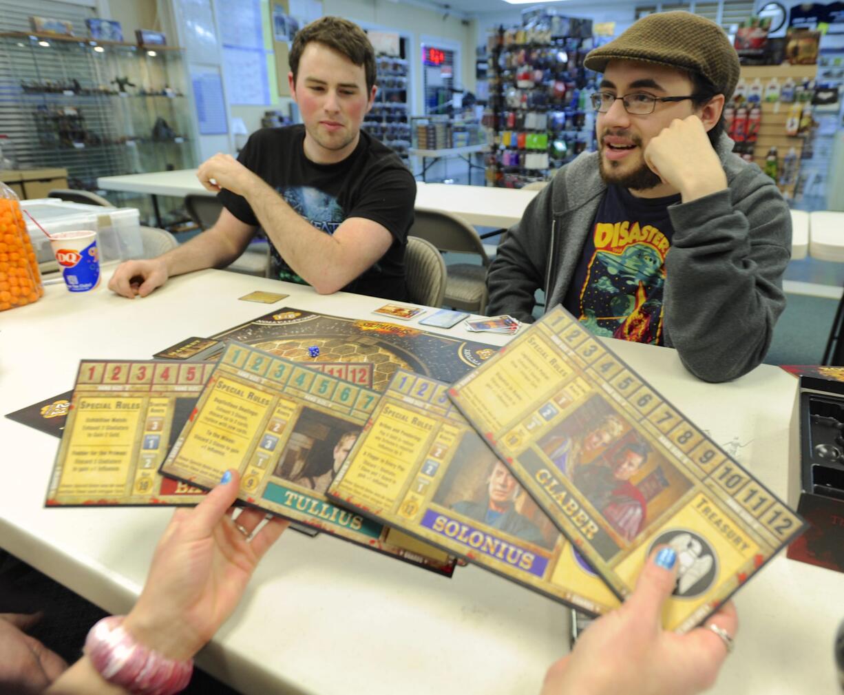 Board gamer Seaton Bryan, right, explains the rules of &quot;Spartacus&quot;  to other players including Robert Wood, at the Dice Age store in Vancouver.