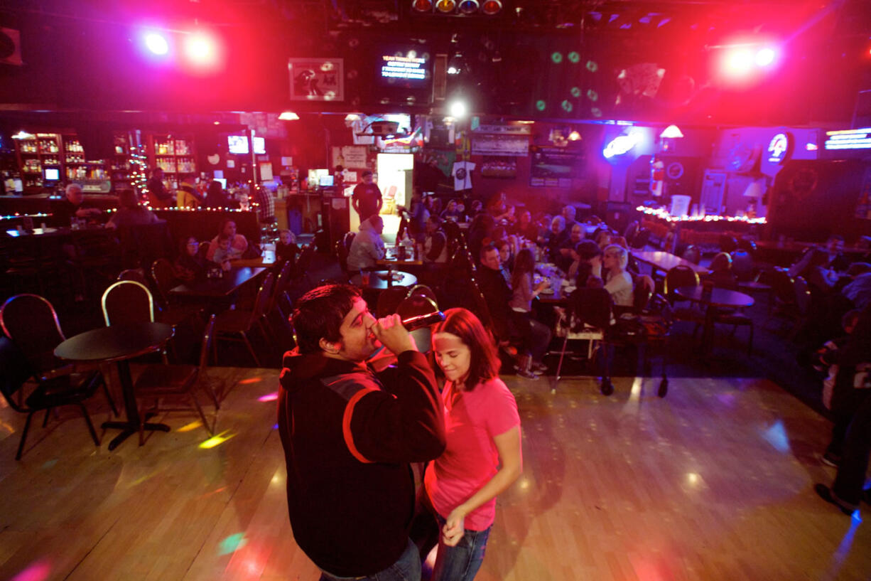 Kesheva Sreshta, 24, sings karaoke as Patty Johnson, 30, dances along at Irishtown Public House during Friday Family Karaoke Night.