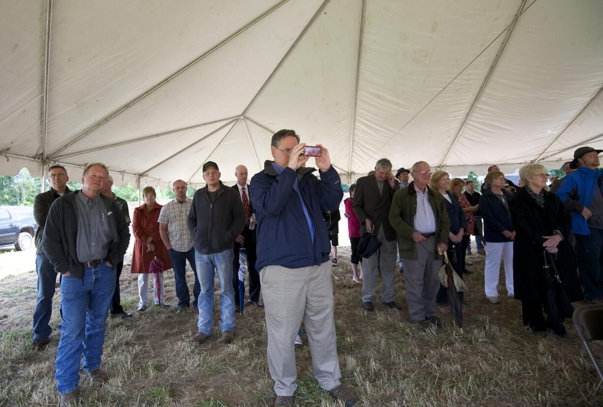 A crowd listens to Washington Gov.